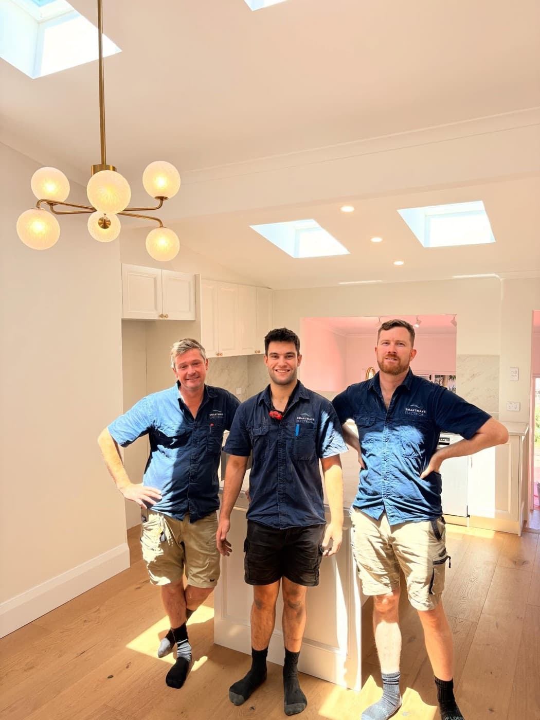 Three Smartwave electricians in a finished kitchen