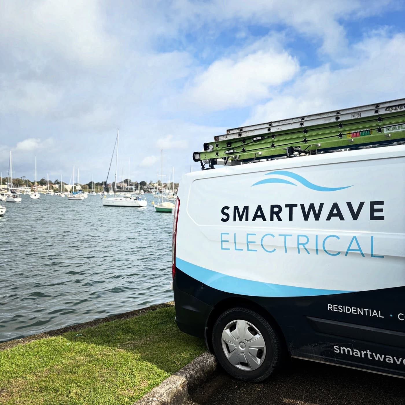 A Smartwave Electrical van parked beside the harbour